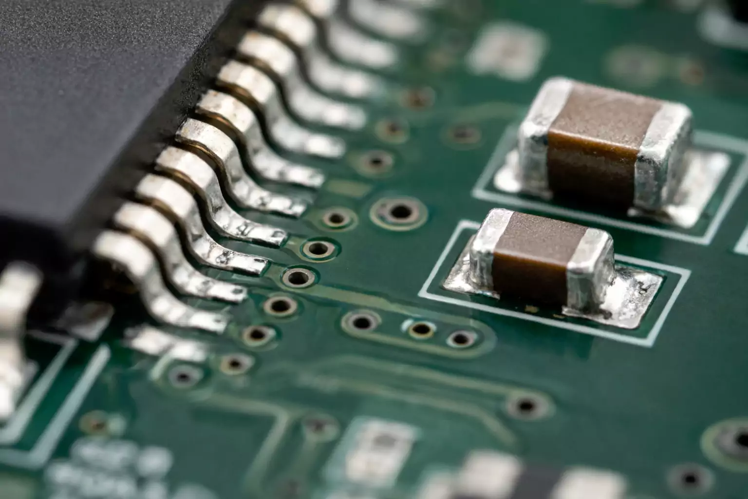 Macro photo of SMT reflow solder joints on QFP and 0402