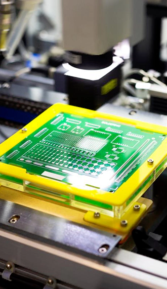 Custom PCB undergoing optical inspection setup with a green test fixture and mounted board.